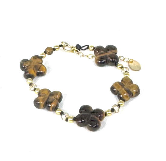 La simplicité fun du lien, la force du trèfle à quatre feuilles.
Bracelet sur cordon -  Trèfles en œil de tigre - Perles d'onyx et en or laminé 14 carats.