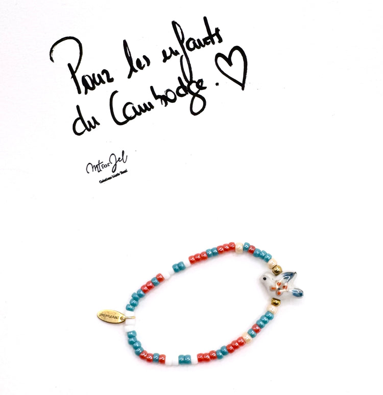 Capsule humanitaire pour les enfants du Cambodge.
Bracelet élastique pour les grandes et les petites -  Perle oiseau en céramique bleu et orange - Perles de rocaille.