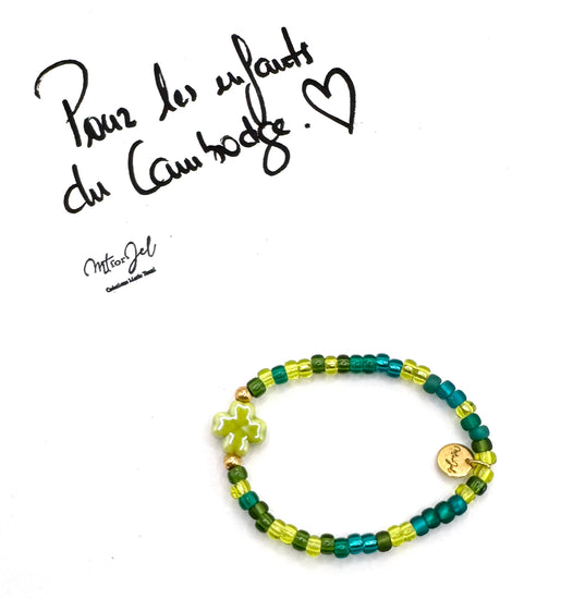 Capsule humanitaire pour les enfants du Cambodge.

Bracelet élastique pour les grandes et les petites - Perle trèfle en céramique vert - Perles de rocaille.