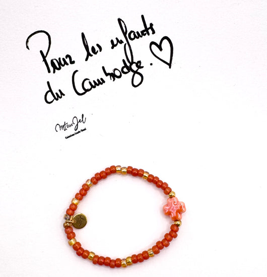 Capsule humanitaire pour les enfants du Cambodge.

Bracelet élastique pour les grandes et les petites - Perle trèfle en céramique orange -Perles de rocaille.